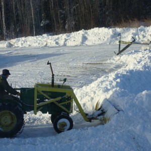 J.D. "M" plowing snow